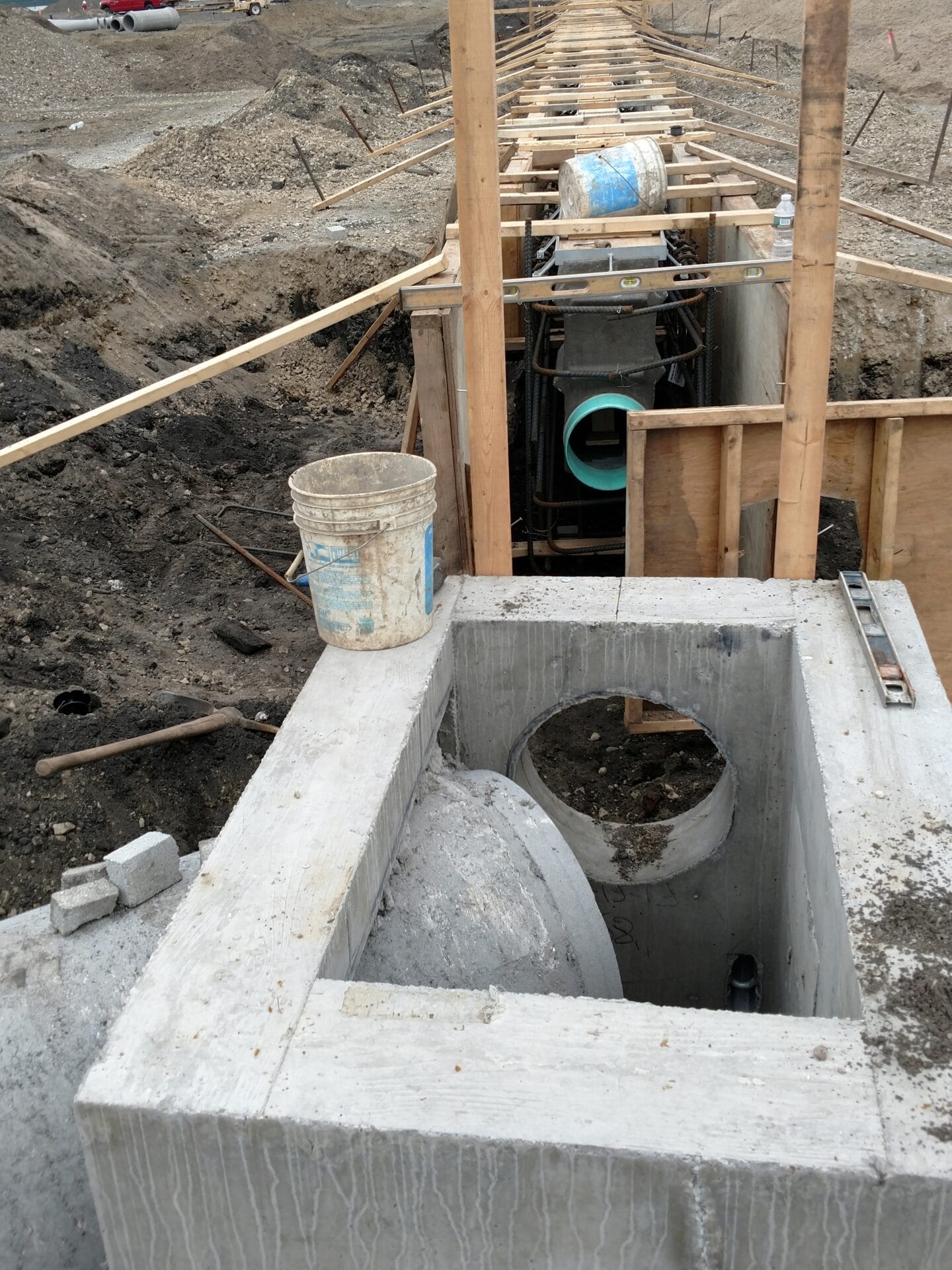 Connecting a trench drain to a concrete manhole structure