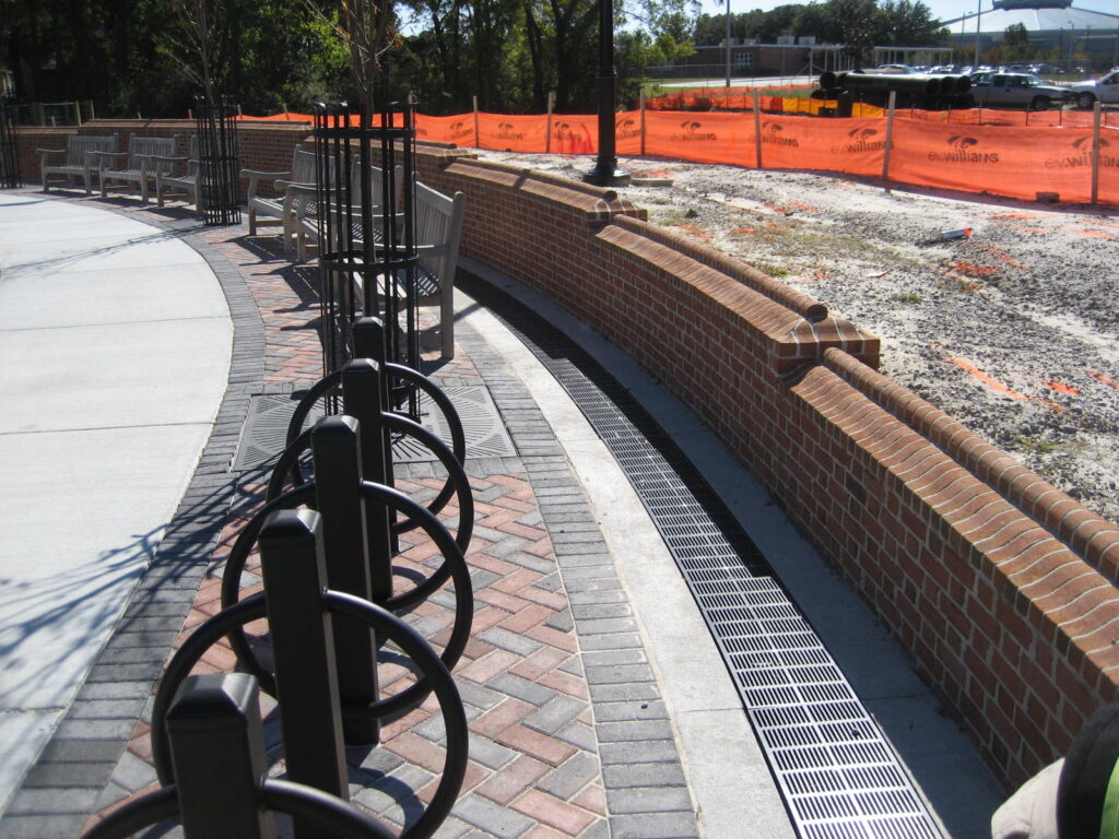 Curved trench drain at park retaining wall